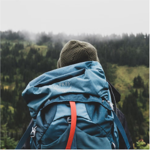 Person wearing backpack from rear view