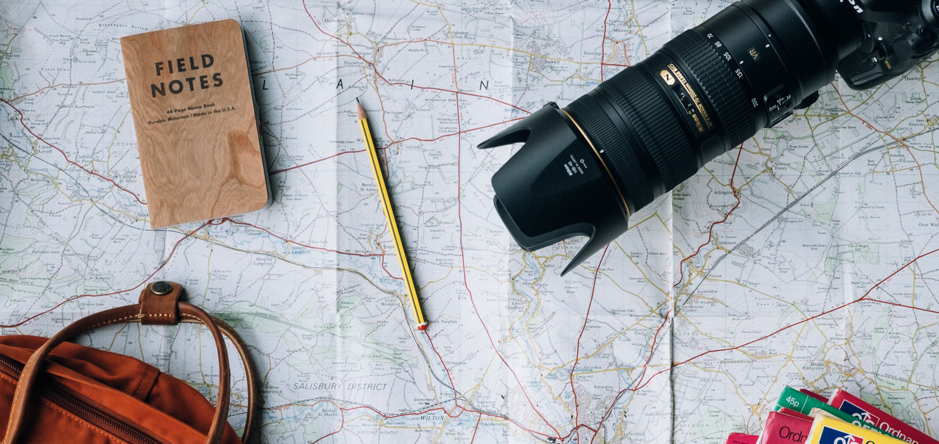 Travel accessories strewn across map of UK