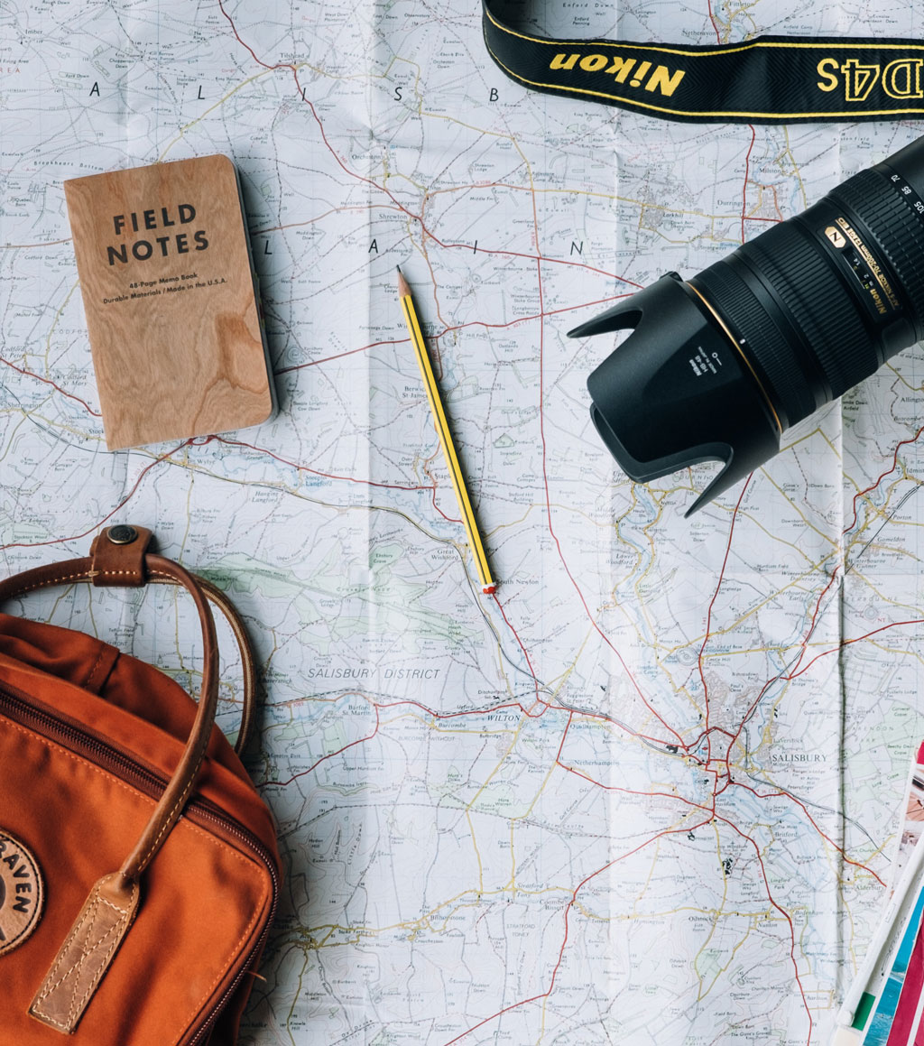 Travel accessories strewn across map of UK